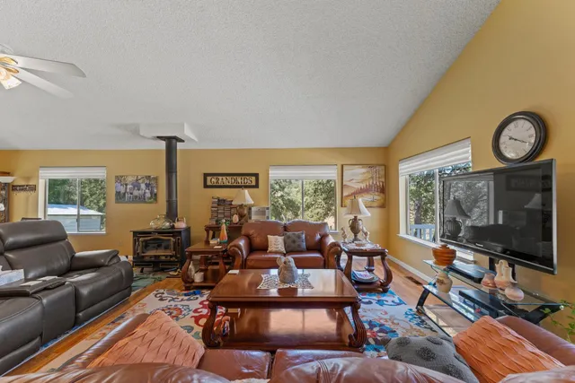 a dining hall with stainless steel appliances kitchen island granite countertop furniture and a kitchen view