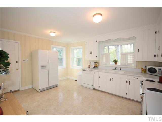 705 Brighton Road Durham, NC 27707 - Photo 5 of 24 The large kitchen has lots of cabinet space, original classic free-standing range, modern dishwasher, and rear door to the backyard vegitable garden (which you will need to plant this year).