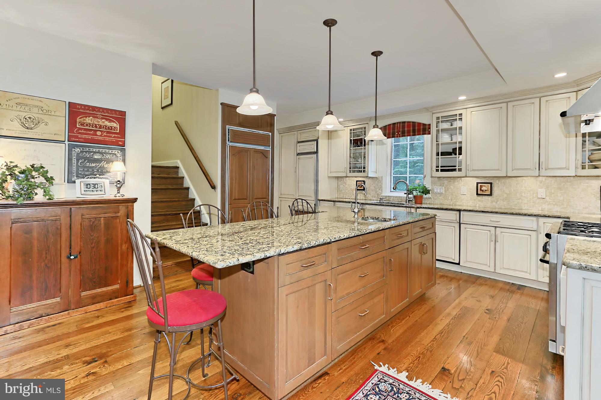 6729 Surbiton Drive Clifton, VA 20124 - Photo 11 of 25 a kitchen with stainless steel appliances kitchen island granite countertop a stove a sink and a wooden cabinets