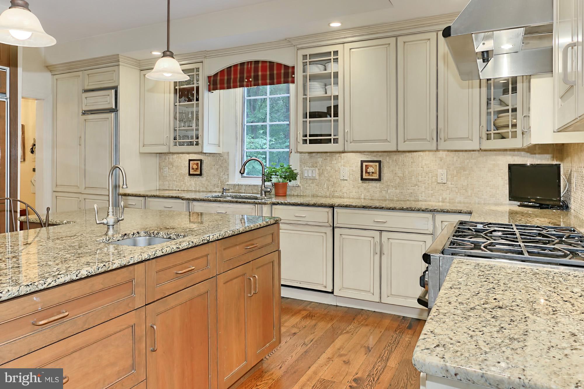 6729 Surbiton Drive Clifton, VA 20124 - Photo 12 of 25 a kitchen with stainless steel appliances granite countertop a sink stove and cabinets