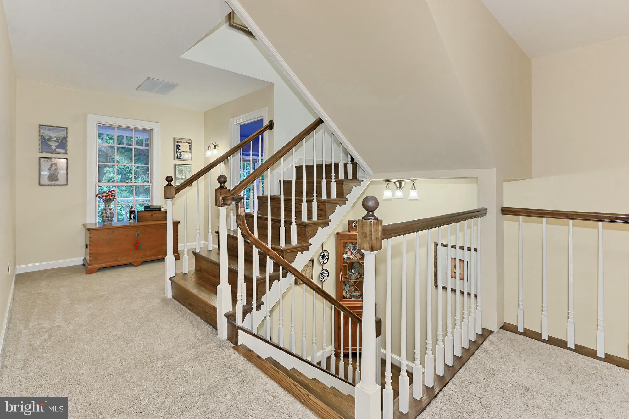 6729 Surbiton Drive Clifton, VA 20124 - Photo 13 of 25 a view of staircase with lots of frames on wall and a large window