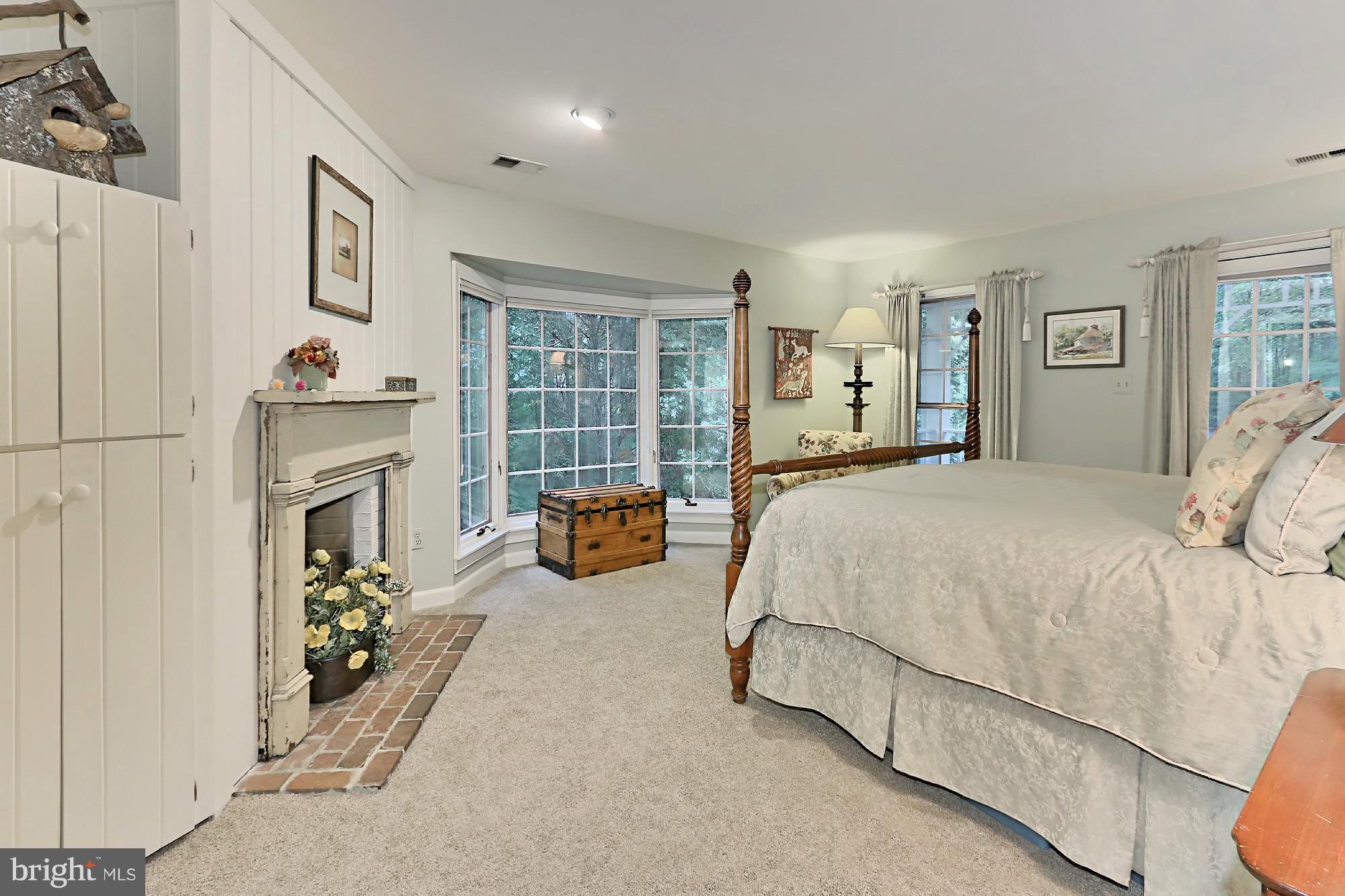 6729 Surbiton Drive Clifton, VA 20124 - Photo 14 of 25 a spacious bedroom with a bed and a couch