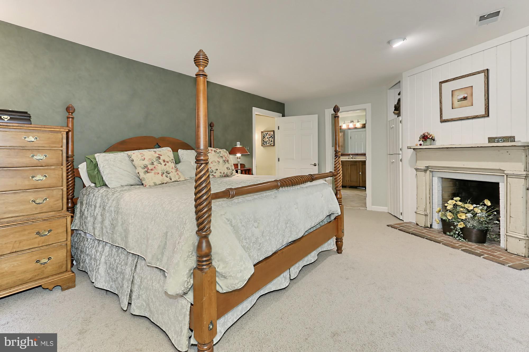 6729 Surbiton Drive Clifton, VA 20124 - Photo 15 of 25 a spacious bedroom with a bed and a fireplace