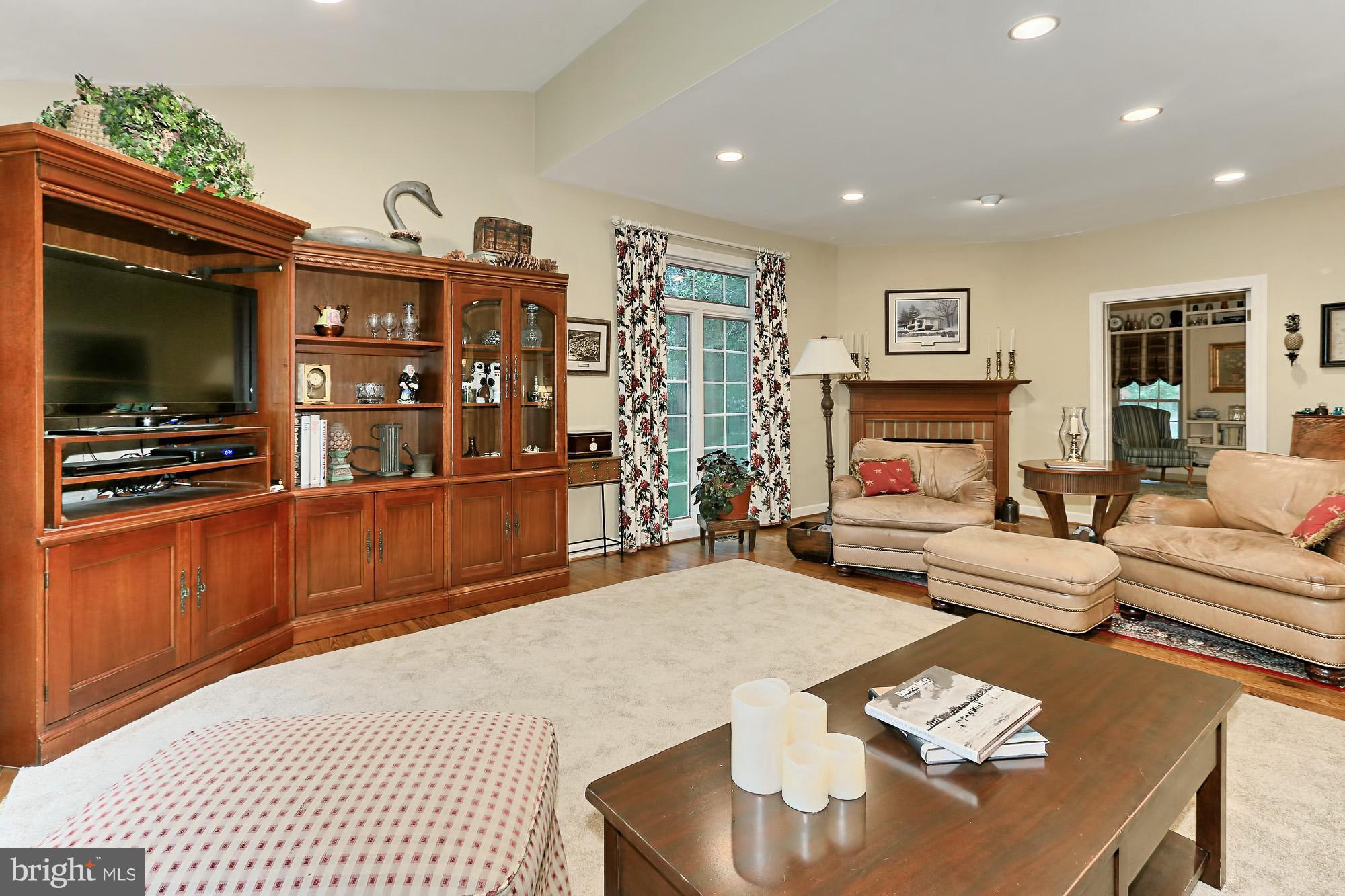 6729 Surbiton Drive Clifton, VA 20124 - Photo 5 of 25 a living room with furniture a flat screen tv and kitchen view
