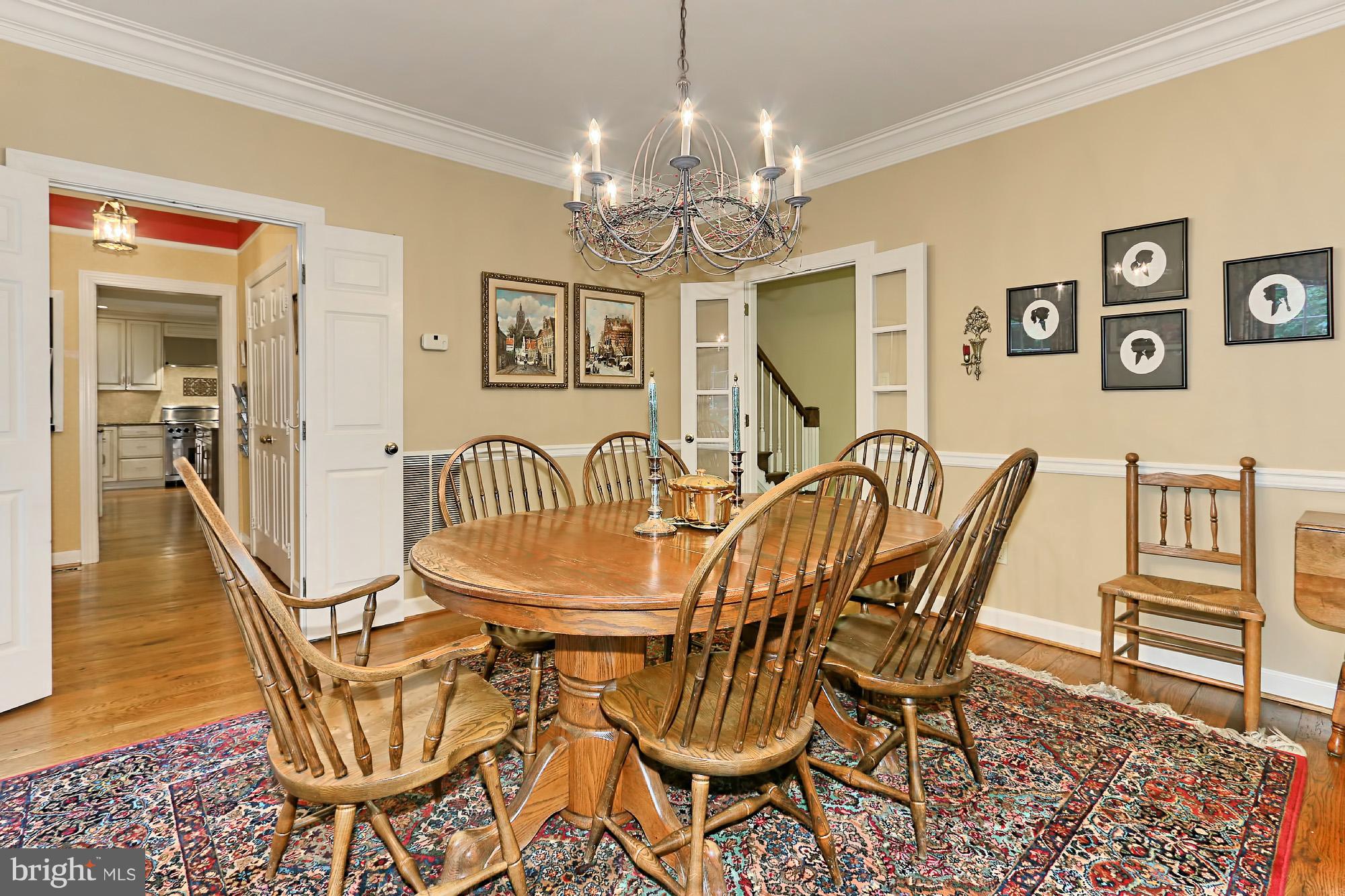 6729 Surbiton Drive Clifton, VA 20124 - Photo 7 of 25 a dining room with furniture a chandelier and wooden floor