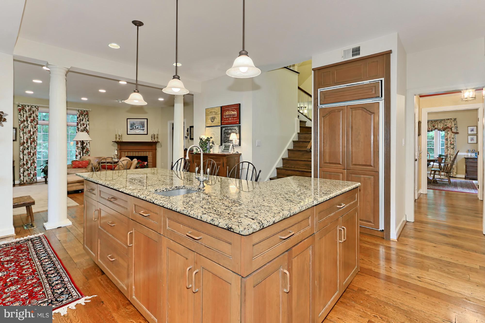 6729 Surbiton Drive Clifton, VA 20124 - Photo 9 of 25 a kitchen with center island table and chairs
