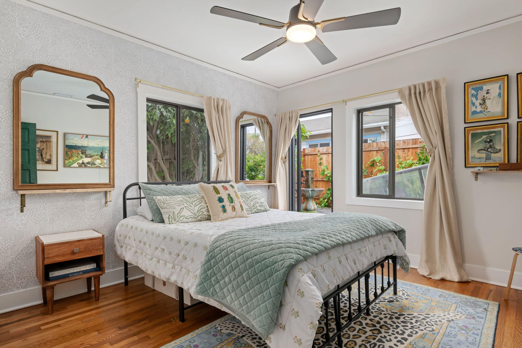 802 Olive Street Santa Barbara, CA 93101 - Photo 15 of 26 a bedroom with a large bed a chandelier and windows