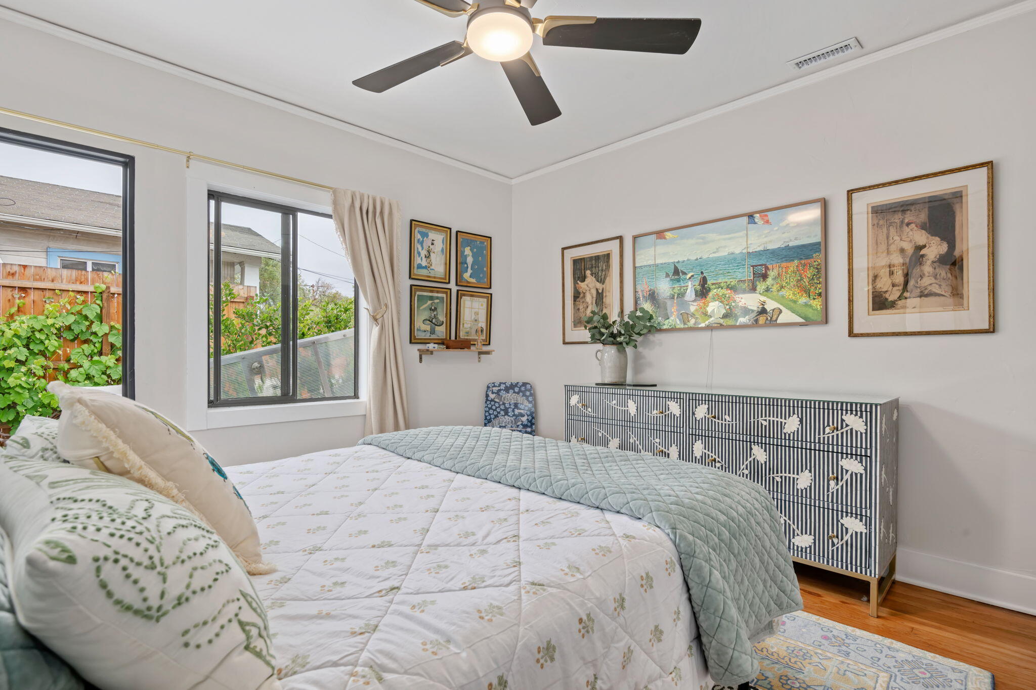 802 Olive Street Santa Barbara, CA 93101 - Photo 16 of 26 a bedroom with a large bed and a chandelier