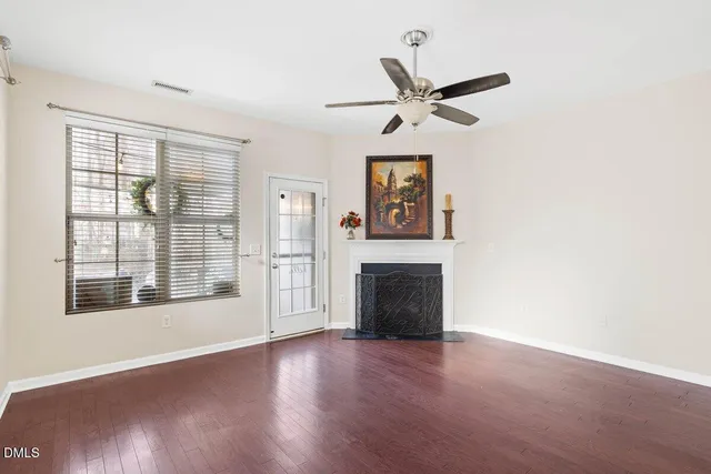 a view of a kitchen with granite countertop wooden floor stainless steel appliances and a chandelier