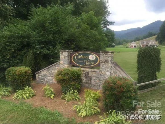 a backyard of a house with a yard and outdoor seating