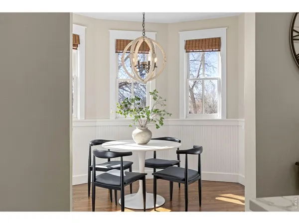 a view of a dining room with furniture and a chandelier