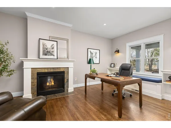 a living room with furniture a fireplace and a window