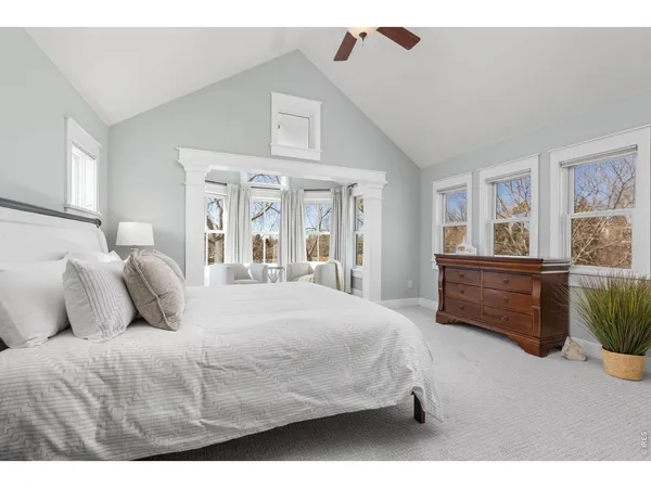 a bedroom with a large bed and a large window