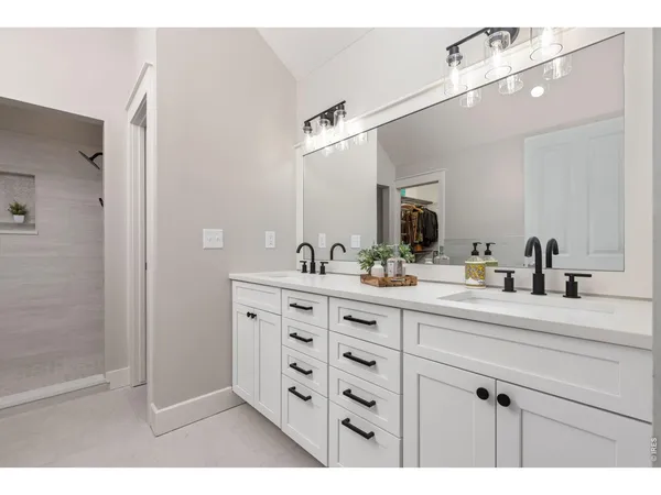 a bathroom with a sink double vanity and a mirror