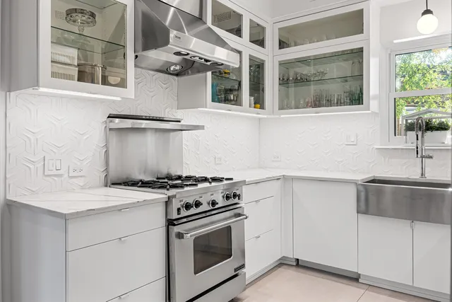 a kitchen with stainless steel appliances granite countertop a stove and a sink