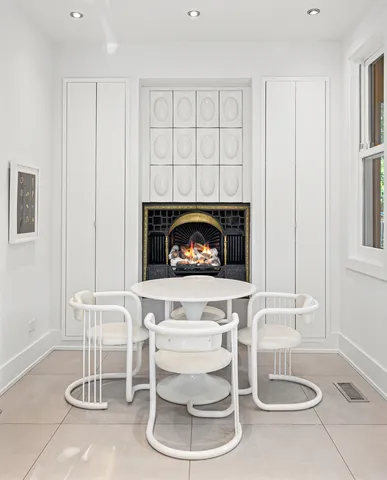 a living room with a fireplace and a table