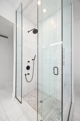 a bathroom with a glass shower door