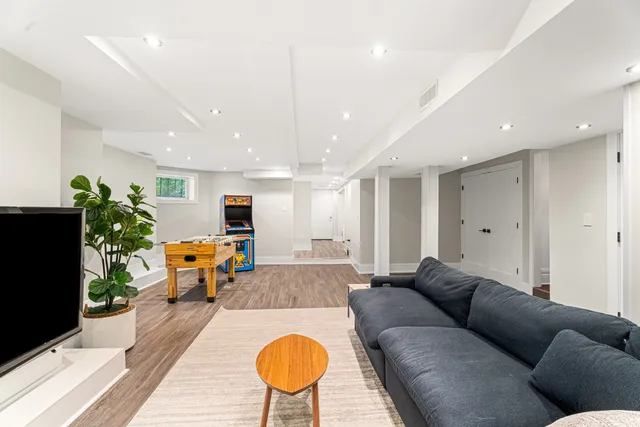 a living room with furniture and a wooden floor