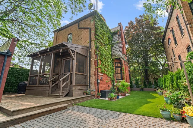a view of a backyard with potted plants and a bench