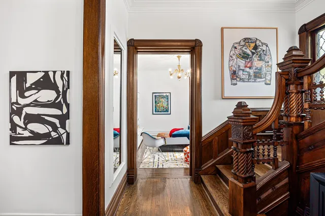 a view of a hallway with workspace and a window