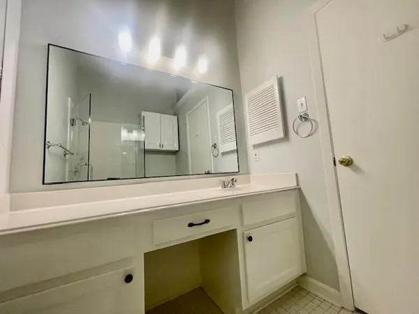 a bathroom with a double vanity sink mirror and double