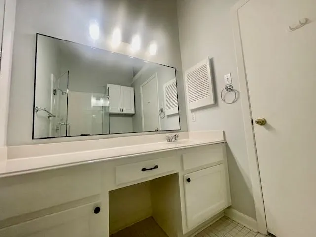 a bathroom with a double vanity sink mirror and double
