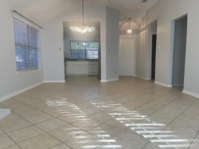 a view of a room that has a lot of cabinets and window
