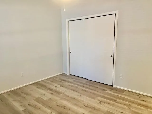 a view of a small space with wooden floor and a bathroom