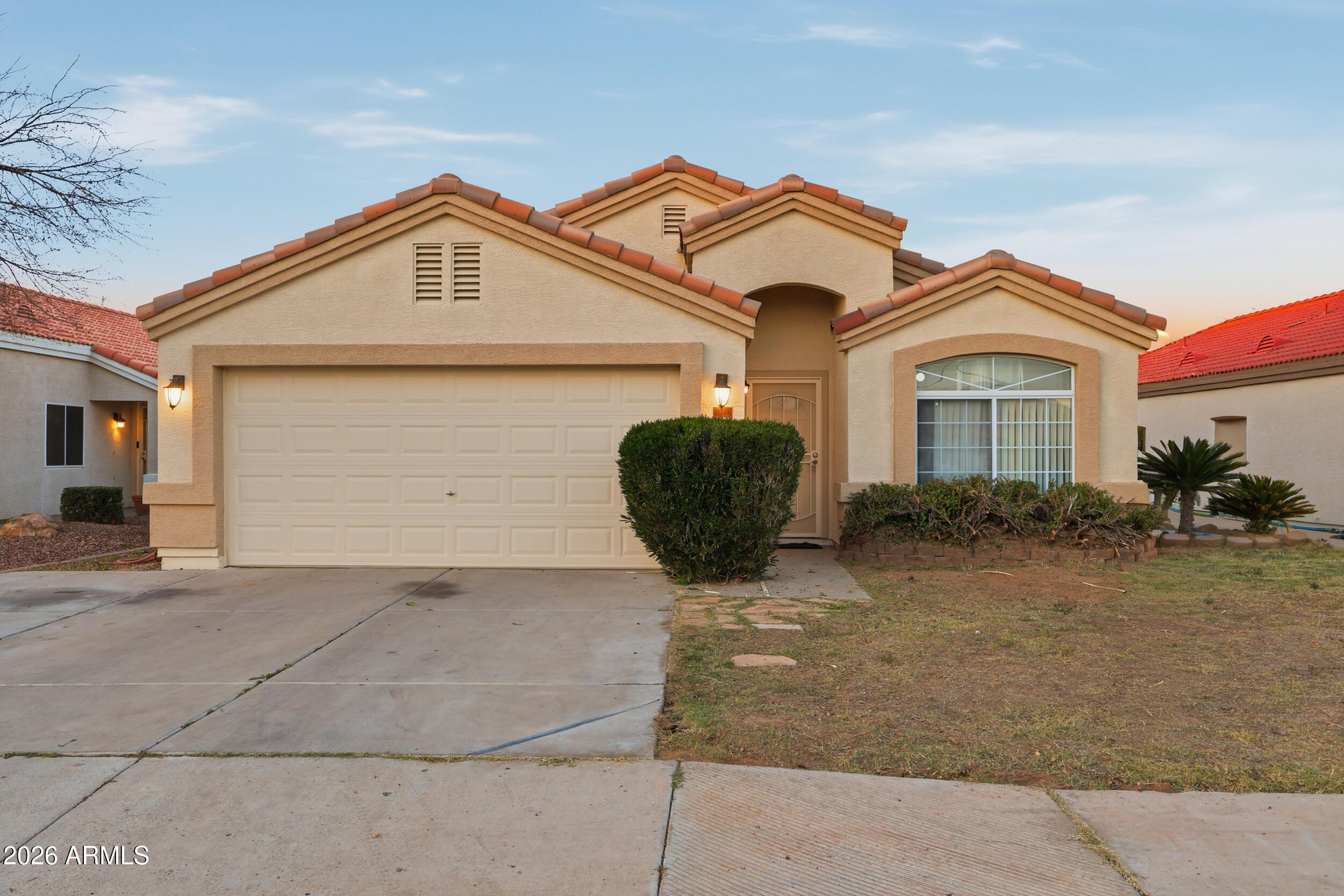 a front view of a house with a yard and garage