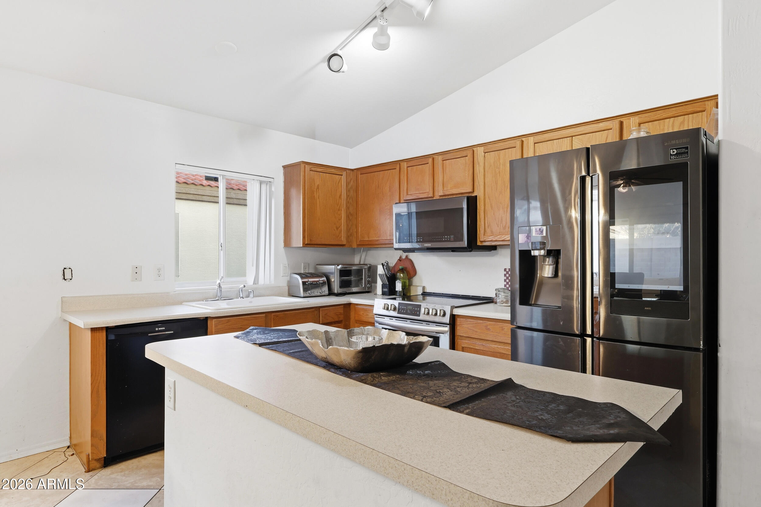 11964 West Granada Road Avondale, AZ 85392 - Photo 11 of 36 a kitchen with granite countertop a refrigerator stove and sink
