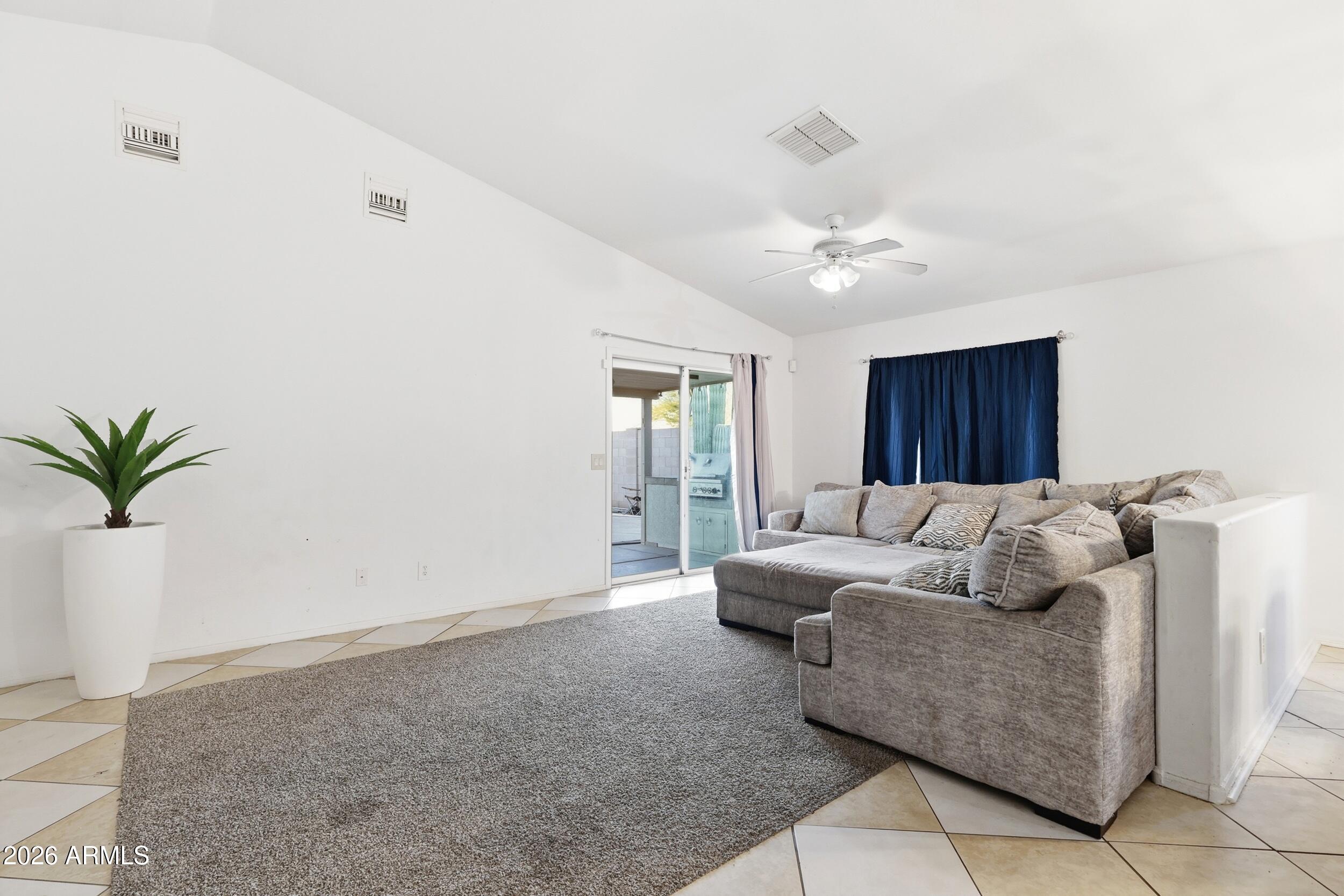 11964 West Granada Road Avondale, AZ 85392 - Photo 14 of 36 a living room with furniture and a potted plant