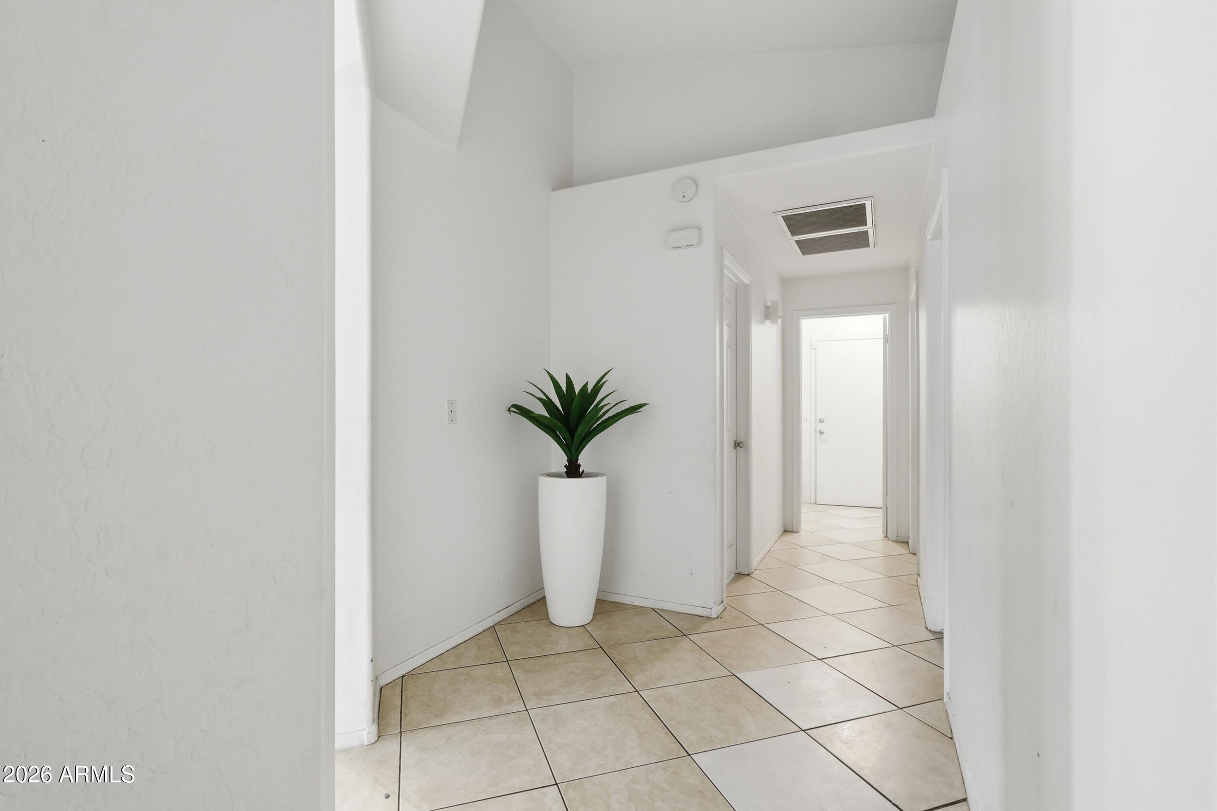 11964 West Granada Road Avondale, AZ 85392 - Photo 17 of 36 a view of a hallway with potted plants