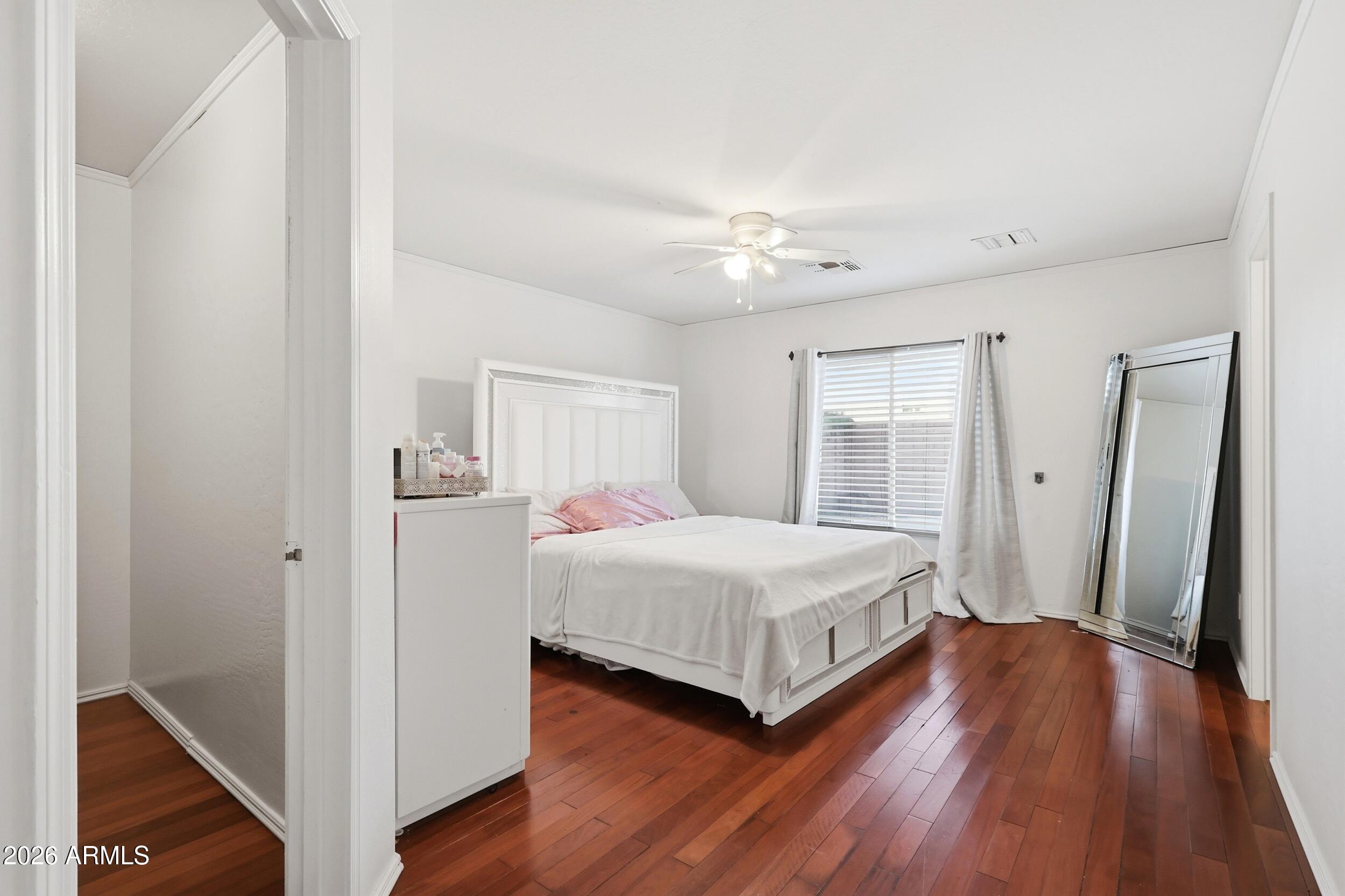 11964 West Granada Road Avondale, AZ 85392 - Photo 18 of 36 a bedroom with a bed and a window