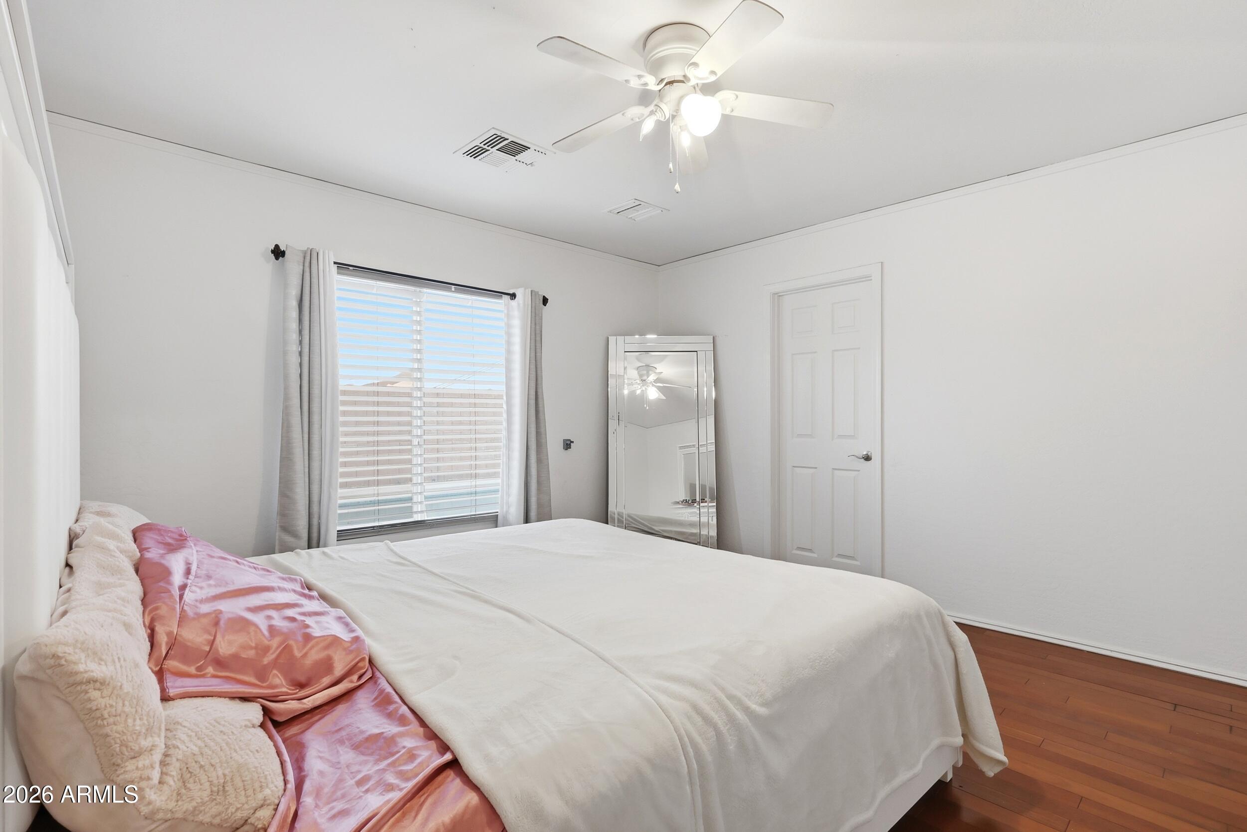 11964 West Granada Road Avondale, AZ 85392 - Photo 20 of 36 a bedroom with a bed dresser and a window