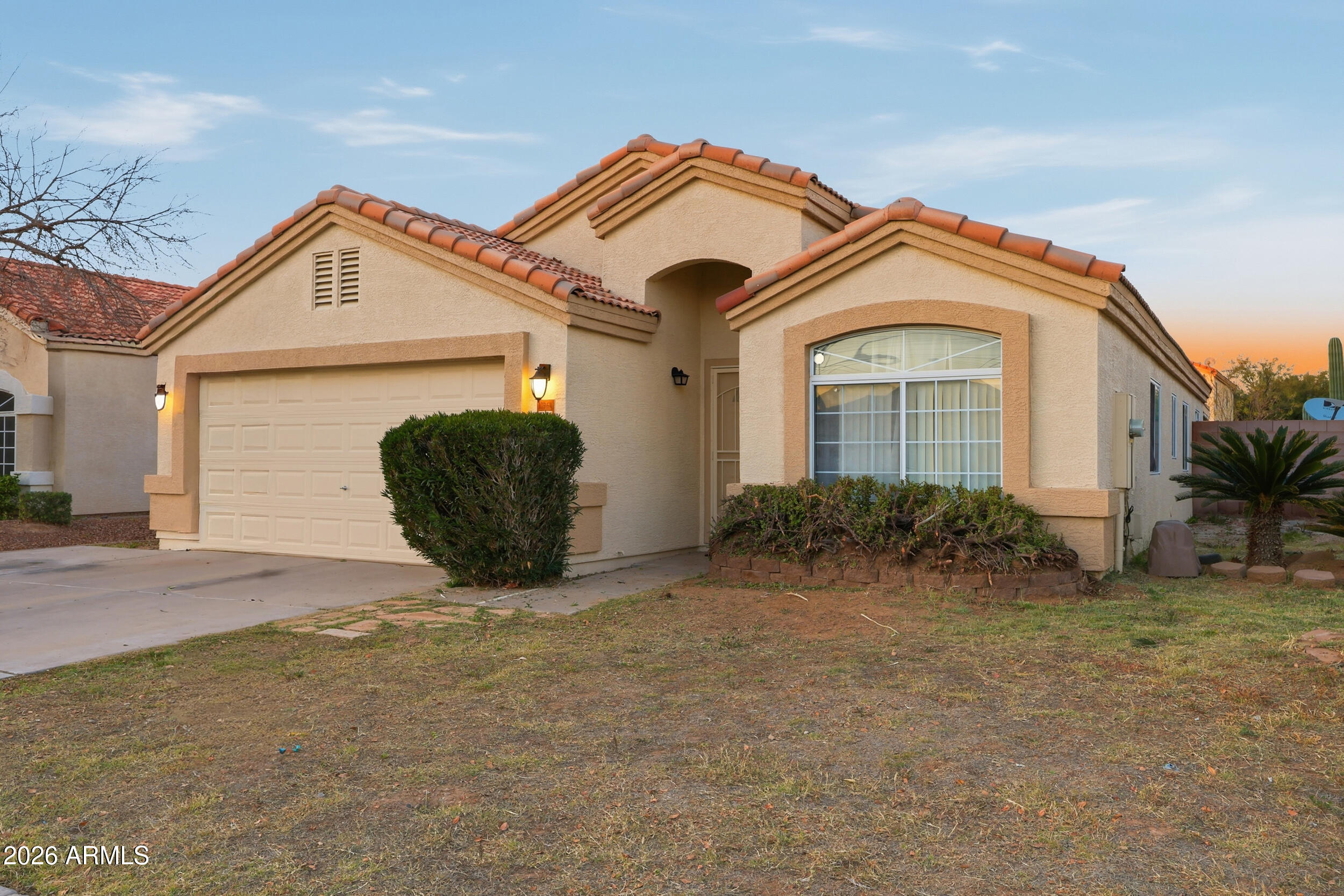 11964 West Granada Road Avondale, AZ 85392 - Photo 2 of 36 a front view of a house with garden