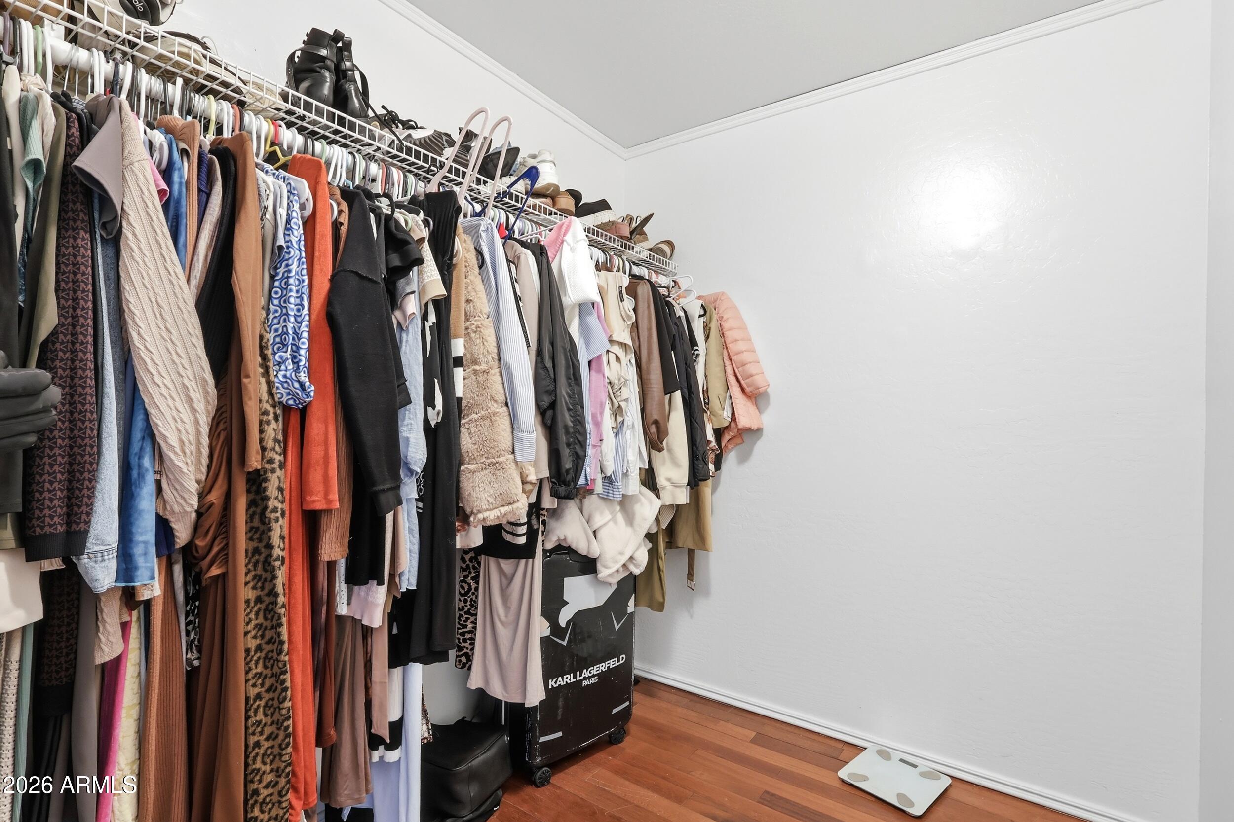 11964 West Granada Road Avondale, AZ 85392 - Photo 23 of 36 a view of walk in closet with clothes
