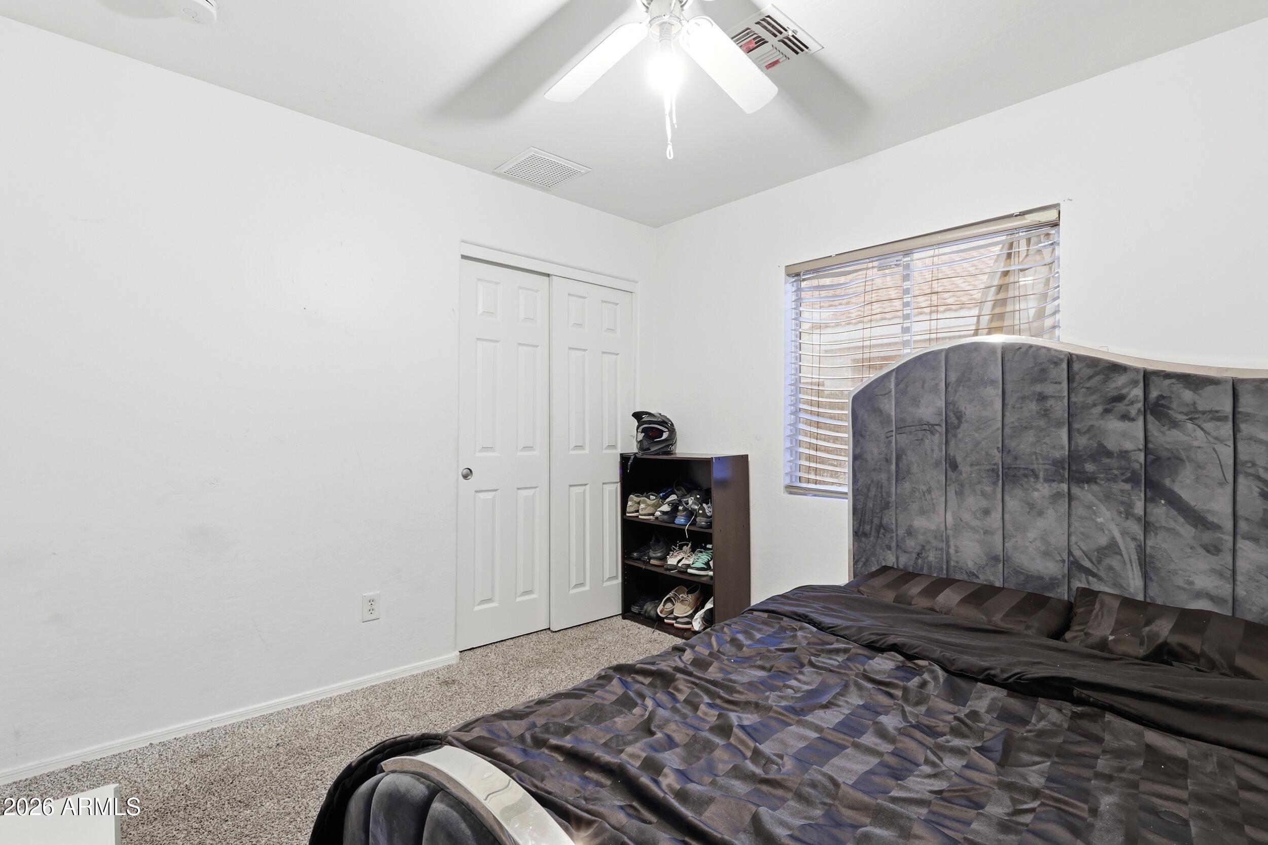 11964 West Granada Road Avondale, AZ 85392 - Photo 25 of 36 a bedroom with a bed and a dresser