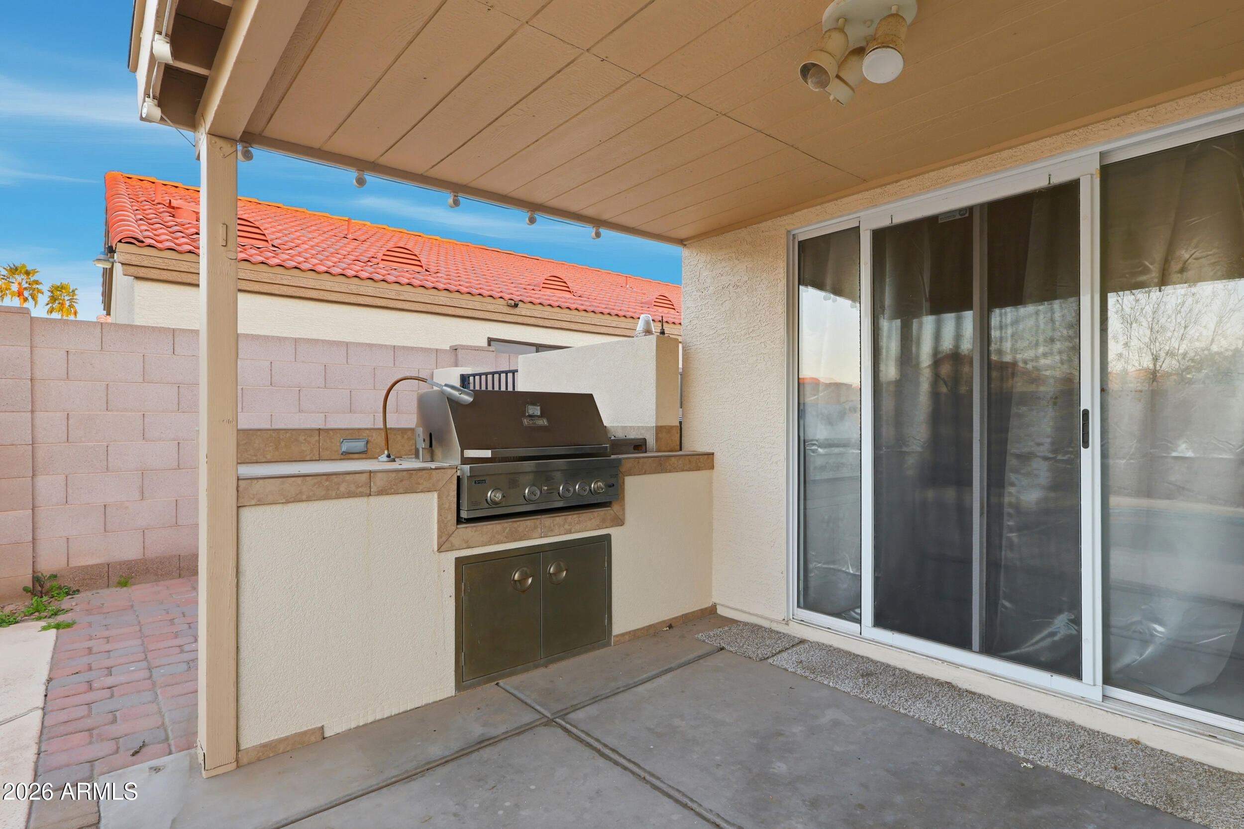 11964 West Granada Road Avondale, AZ 85392 - Photo 32 of 36 a kitchen with stainless steel appliances kitchen island granite countertop a refrigerator and a stove
