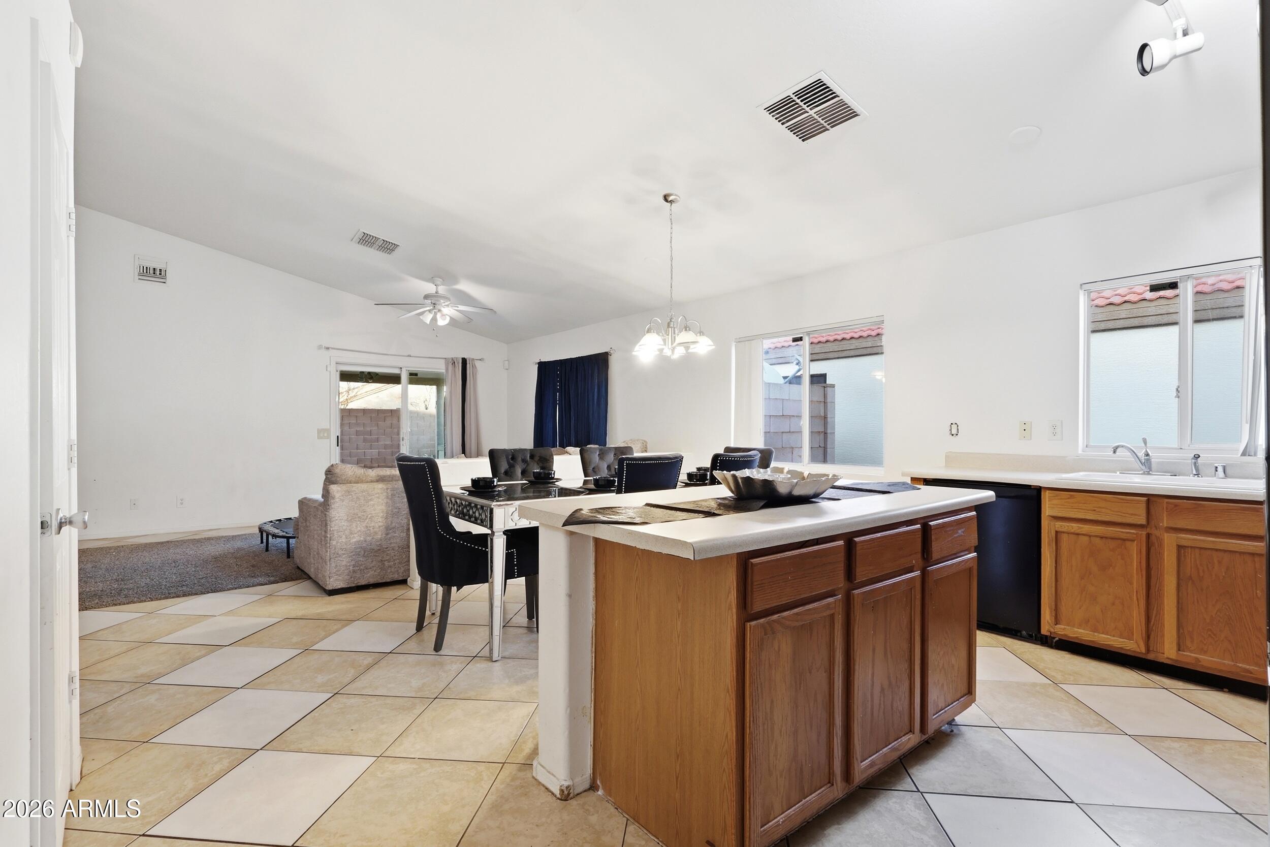 11964 West Granada Road Avondale, AZ 85392 - Photo 8 of 36 a kitchen with a sink stove and cabinets