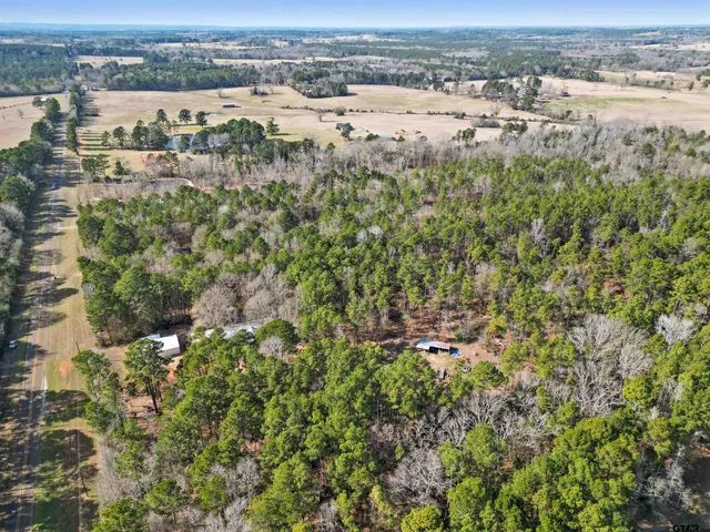 an aerial view of a houses with a yard