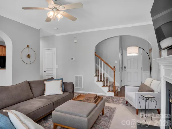 a living room with furniture and a chandelier