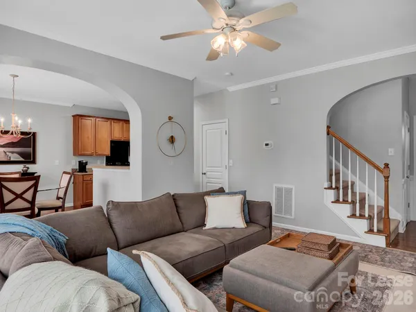 a living room with furniture and a chandelier