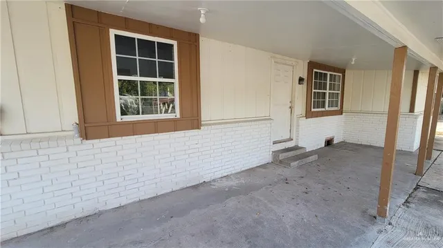 a view of a room with a kitchen