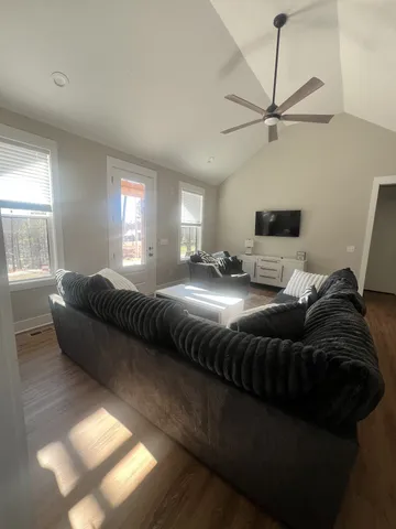 a living room with a bed furniture and a window
