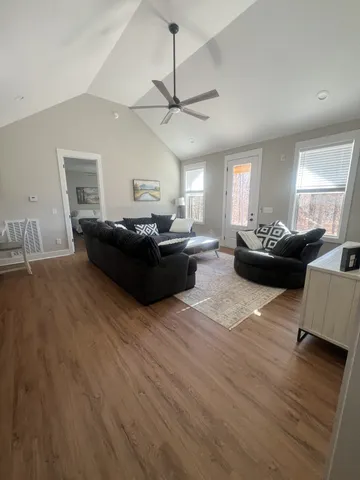 a living room with furniture and a wooden floor