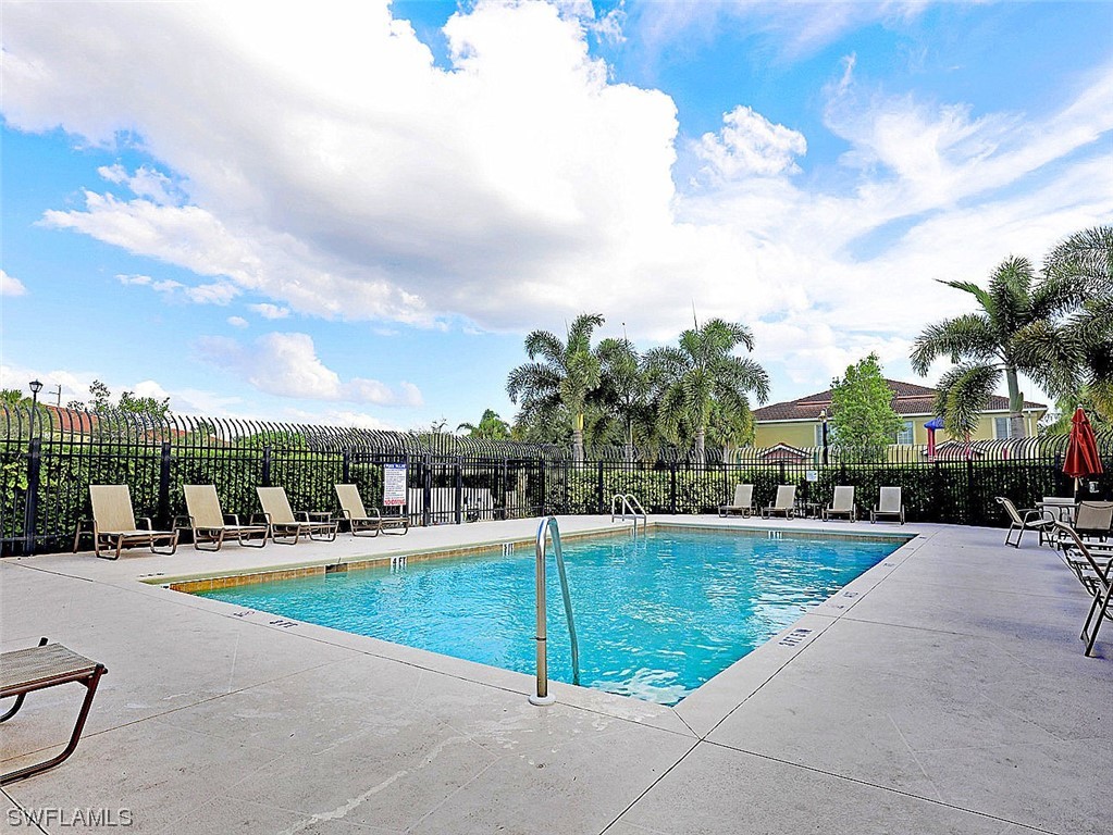 9419 Ivy Brook Run, Unit 1204 Fort Myers, FL 33913 - Photo 18 of 22 a view of a swimming pool with a lawn chairs
