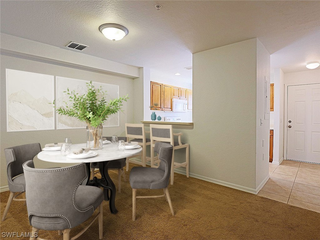 9419 Ivy Brook Run, Unit 1204 Fort Myers, FL 33913 - Photo 6 of 22 a view of a dining room with furniture and window