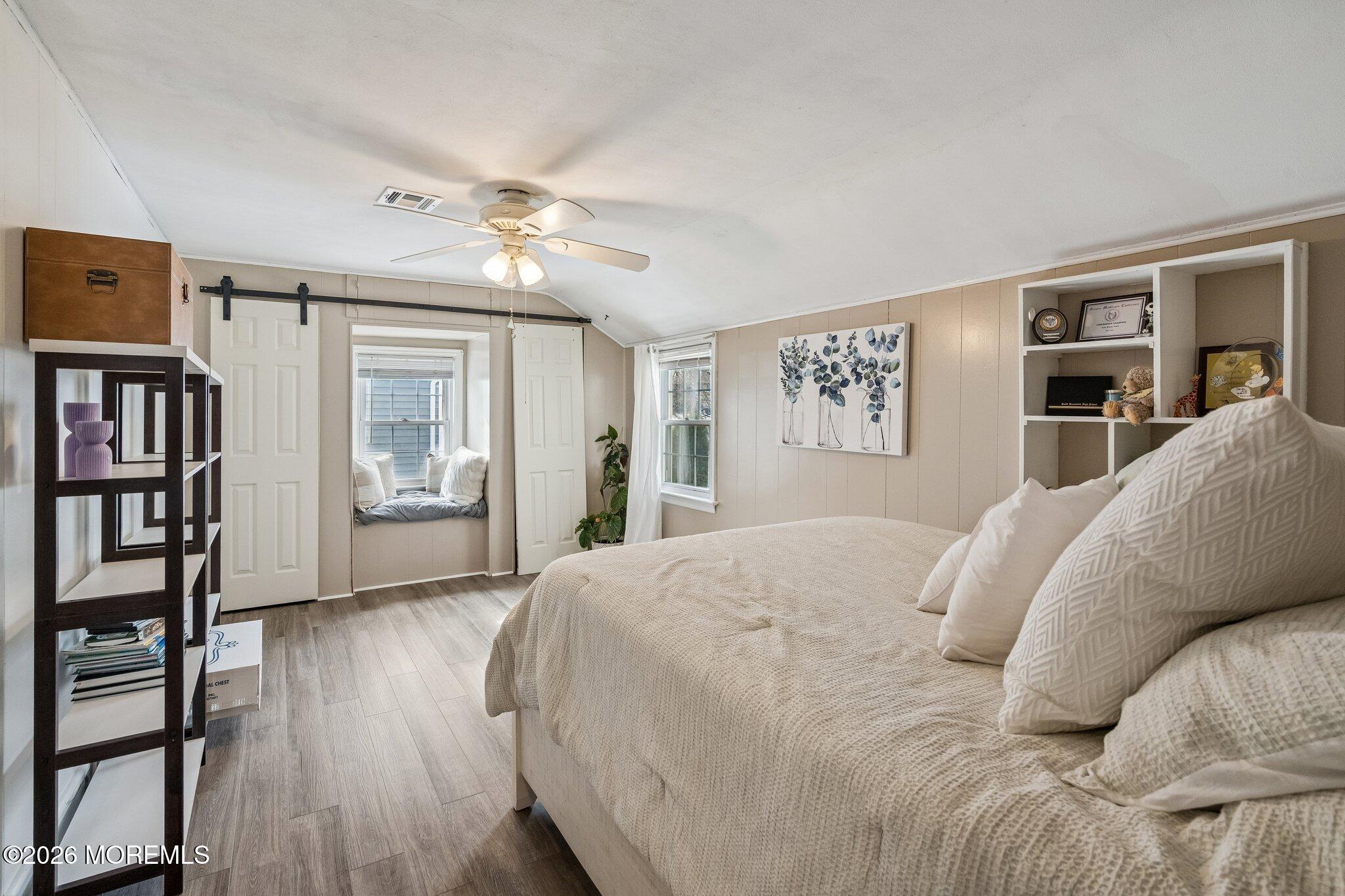 121 Corson Avenue Hamilton, NJ 08619 - Photo 28 of 32 a spacious bedroom with a large bed a chandelier and closet