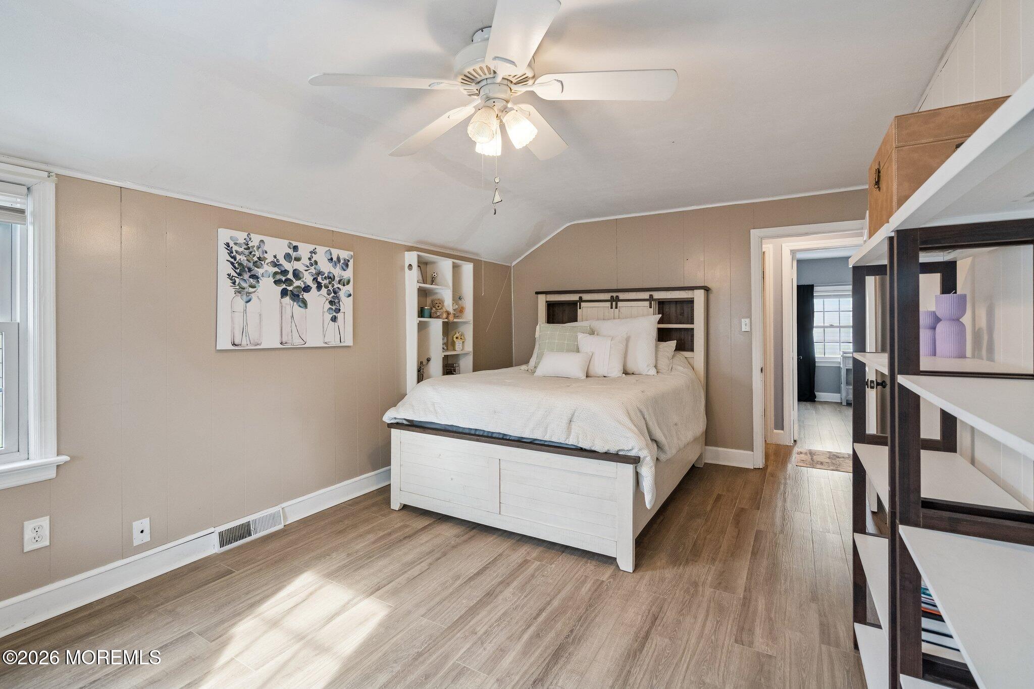 121 Corson Avenue Hamilton, NJ 08619 - Photo 29 of 32 a bedroom with a large bed chandelier and a window