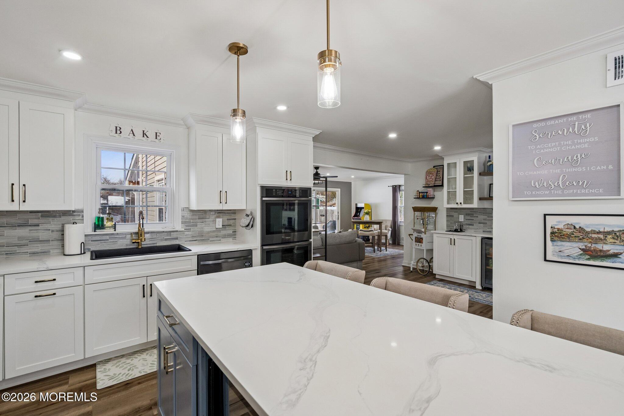 121 Corson Avenue Hamilton, NJ 08619 - Photo 5 of 32 a kitchen with stainless steel appliances kitchen island granite countertop a sink and cabinets